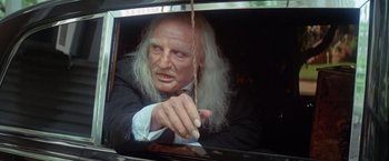 Movie still from “Brewster McCloud” (1970), directed by Robert Altman – An old man with long white hair is holding a wand; Close Up shot, Low angle