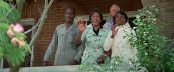 Movie still from “Brewster McCloud” (1970), directed by Robert Altman – A group of people standing next to each other waving; Medium shot, Low angle