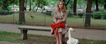 Movie still from “Brewster McCloud” (1970), directed by Robert Altman – A woman sitting on top of a tree holding a purse; Medium shot, Over the shoulder angle