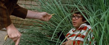 Movie still from “Brewster McCloud” (1970), directed by Robert Altman – A person reaching for a piece of food from a hand; Close Up shot, Over the shoulder angle