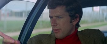 Movie still from “Brewster McCloud” (1970), directed by Robert Altman – A person sitting in a car; Close Up shot, Low angle