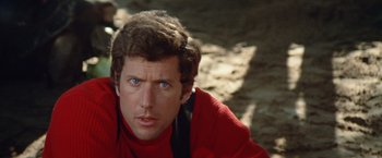 Movie still from “Brewster McCloud” (1970), directed by Robert Altman – A person wearing a red shirt; Close Up shot, Low angle
