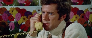 Movie still from “Brewster McCloud” (1970), directed by Robert Altman – A person talking on a phone; Close Up shot, Low angle