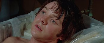 Movie still from “Brewster McCloud” (1970), directed by Robert Altman – A person with blue eyes; Close Up shot, Overhead angle