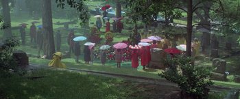 Movie still from “Brewster McCloud” (1970), directed by Robert Altman – A group of people standing under umbrellas in a park; Extreme Wide shot, High angle