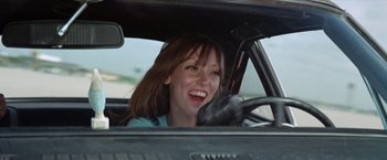 Movie still from “Brewster McCloud” (1970), directed by Robert Altman – A woman sitting in the driver's seat of a car; Close Up shot, Low angle