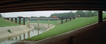Movie still from “Brewster McCloud” (1970), directed by Robert Altman – A view of a bridge from a car window; Extreme Wide shot, High angle