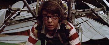 Movie still from “Brewster McCloud” (1970), directed by Robert Altman – A young man wearing a striped shirt and glasses; Close Up shot, Low angle