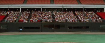 Movie still from “Brewster McCloud” (1970), directed by Robert Altman – A crowd of people sitting in the stands at a baseball game; Extreme Wide shot, High angle