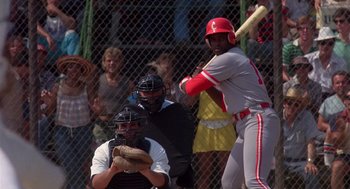 Movie still from “Brewster's Millions” (1985), directed by Walter Hill – A baseball player swinging at a pitch during a baseball game; Medium shot, Over the shoulder angle