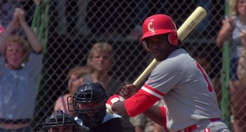 Movie still from “Brewster's Millions” (1985), directed by Walter Hill – A baseball player holding a baseball bat on top of a baseball field; Medium shot, Over the shoulder angle