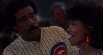 Movie still from “Brewster's Millions” (1985), directed by Walter Hill – A man and a woman in a baseball uniform; Close Up shot, Over the shoulder angle