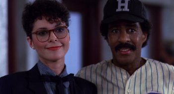 Movie still from “Brewster's Millions” (1985), directed by Walter Hill – A man and a woman standing next to each other; Close Up shot, Over the shoulder angle