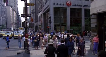 Movie still from “Brewster's Millions” (1985), directed by Walter Hill – A crowd of people walking down a street; Extreme Wide shot, High angle