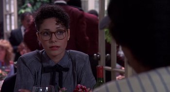 Movie still from “Brewster's Millions” (1985), directed by Walter Hill – A woman sitting at a table with a glass of wine in front of a man; Close Up shot, Over the shoulder angle