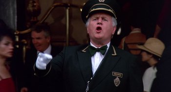 Movie still from “Brewster's Millions” (1985), directed by Walter Hill – A man in a green suit and a green hat; Close Up shot, Low angle