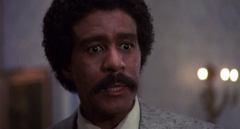 Movie still from “Brewster's Millions” (1985), directed by Walter Hill – A person wearing a suit and tie; Close Up shot, Low angle