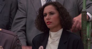 Movie still from “Brewster's Millions” (1985), directed by Walter Hill – A woman in a black suit and white shirt; Close Up shot, Low angle