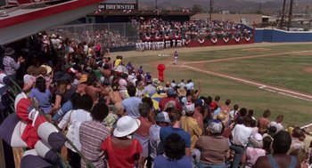 Movie still from “Brewster's Millions” (1985), directed by Walter Hill – A crowd of people are watching a baseball game; Extreme Wide shot, High angle