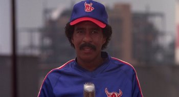 Movie still from “Brewster's Millions” (1985), directed by Walter Hill – A man with a microphone in his hand; Close Up shot, Low angle