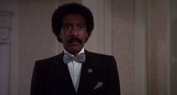 Movie still from “Brewster's Millions” (1985), directed by Walter Hill – A man in a suit and a bow tie; Close Up shot, Low angle