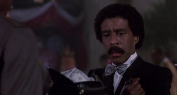 Movie still from “Brewster's Millions” (1985), directed by Walter Hill – A man that is looking at the money in his wallet; Close Up shot, Low angle