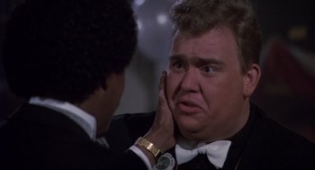 Movie still from “Brewster's Millions” (1985), directed by Walter Hill – A person with his hand on his face; Close Up shot, Over the shoulder angle