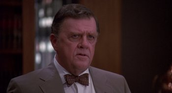 Movie still from “Brewster's Millions” (1985), directed by Walter Hill – An older man in a suit and bow tie; Close Up shot, High angle