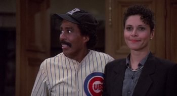 Movie still from “Brewster's Millions” (1985), directed by Walter Hill – A man and a woman are posing for a picture; Medium shot, High angle