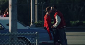 Movie still from “Brick” (2005), directed by Rian Johnson – A man and a woman kissing on the hood of a car; Medium shot, Low angle