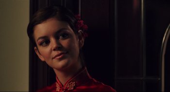 Movie still from “Brick” (2005), directed by Rian Johnson – A young woman in a red dress with a flower in her hair; Close Up shot, Over the shoulder angle