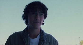 Movie still from “Brick” (2005), directed by Rian Johnson – A young man wearing glasses and a jacket; Close Up shot, Low angle