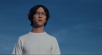 Movie still from “Brick” (2005), directed by Rian Johnson – A young man wearing glasses and a white t - shirt; Close Up shot, Low angle
