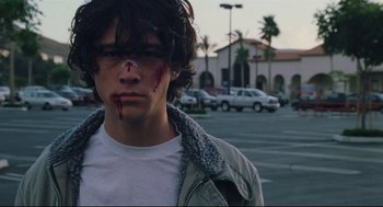 Movie still from “Brick” (2005), directed by Rian Johnson – A young man with blood on his face; Close Up shot, Low angle