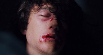 Movie still from “Brick” (2005), directed by Rian Johnson – A young man with blood all over his face; Close Up shot, Overhead angle
