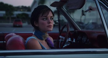 Movie still from “Brick” (2005), directed by Rian Johnson – A woman sitting in the driver's seat of a car; Close Up shot, Over the shoulder angle