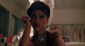 Movie still from “Brick” (2005), directed by Rian Johnson – A woman in a black hat and a black dress; Close Up shot, Over the shoulder angle