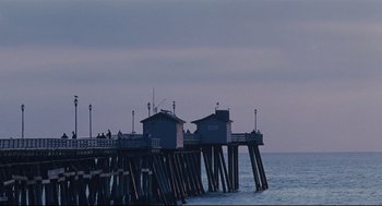 Movie still from “Brick” (2005), directed by Rian Johnson – A couple of people sitting on top of a pier; Extreme Wide shot, Low angle