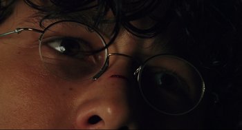Movie still from “Brick” (2005), directed by Rian Johnson – A person wearing glasses; Extreme Close Up shot, Overhead angle