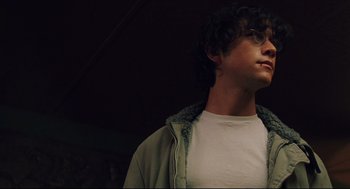 Movie still from “Brick” (2005), directed by Rian Johnson – A young man wearing glasses and a white t - shirt; Close Up shot, Low angle