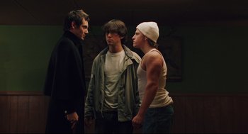 Movie still from “Brick” (2005), directed by Rian Johnson – A group of young men standing next to each other in a room; Medium shot, Low angle