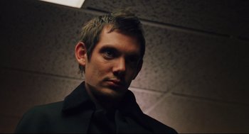 Movie still from “Brick” (2005), directed by Rian Johnson – A person wearing a black shirt and tie; Close Up shot, Low angle