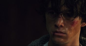 Movie still from “Brick” (2005), directed by Rian Johnson – A person wearing glasses and a sweater; Close Up shot, High angle