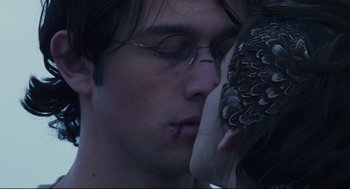 Movie still from “Brick” (2005), directed by Rian Johnson – A person kissing another person on the cheek; Extreme Close Up shot, Over the shoulder angle