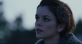 Movie still from “Brick” (2005), directed by Rian Johnson – A person wearing a feather headband; Close Up shot, Low angle