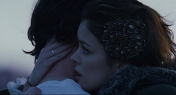 Movie still from “Brick” (2005), directed by Rian Johnson – A woman and a man embracing each other in the dark; Close Up shot, Over the shoulder angle