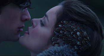 Movie still from “Brick” (2005), directed by Rian Johnson – A person with feathers on their head; Close Up shot, Over the shoulder angle