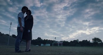Movie still from “Brick” (2005), directed by Rian Johnson – Two women standing in a field at dusk; Wide shot, Low angle