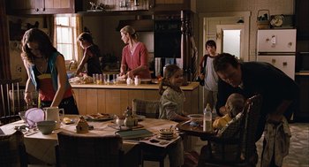 Movie still from “Bridge to Terabithia” (2007), directed by Gabor Csupo – A group of people in a kitchen preparing food; Wide shot, Over the shoulder angle