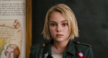 Movie still from “Bridge to Terabithia” (2007), directed by Gabor Csupo – A young girl with blonde hair wearing a green jacket; Close Up shot, High angle